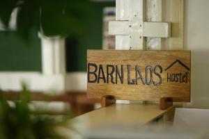 a sign that reads barnums hospital sitting on a table at Barn Laos Hostel in Vientiane