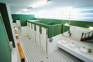a bathroom with two sinks and two toilets at Barn Laos Hostel in Vientiane