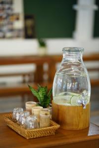 a glass jar filled with liquid sitting on top of a table at Barn Laos Hostel in Vientiane