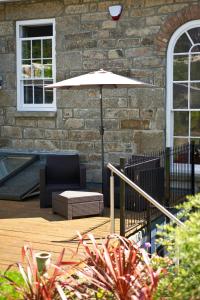 a patio with a chair and an umbrella at 27 The Terrace in St Ives