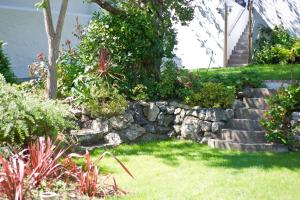 a garden with a stone retaining wall and some plants at 27 The Terrace in St Ives