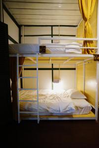 a couple of bunk beds in a room at Barn Laos Hostel in Vientiane