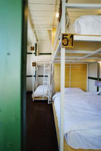 two bunk beds in a room with the number at Barn Laos Hostel in Vientiane