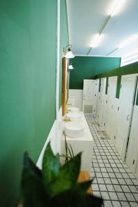 a bathroom with a row of sinks and toilets at Barn Laos Hostel in Vientiane