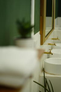 a bathroom with a sink and a mirror at Barn Laos Hostel in Vientiane