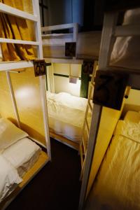 a room with two bunk beds in a room at Barn Laos Hostel in Vientiane