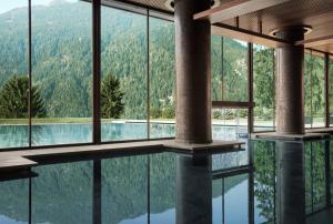 a swimming pool with a view of a mountain at Lefay Resort & SPA Dolomiti in Pinzolo