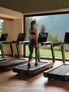
a woman is standing in front of a projection screen at Lefay Resort & SPA Dolomiti in Pinzolo
