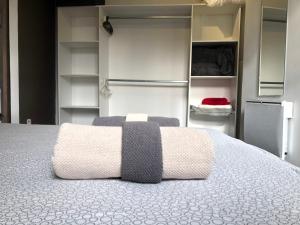a bedroom with a bed and open shelving at T2 Hyper centre clim,WIFI in Hyères