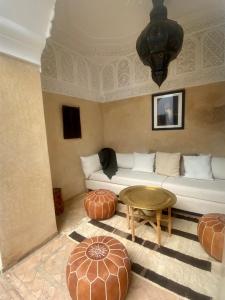 sala de estar con sofá y mesa en Riad Hadika Maria en Marrakech
