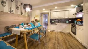 a kitchen with a wooden table and blue chairs at Luxuslodge Wernigerode in Wernigerode