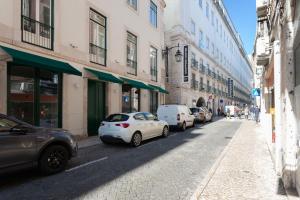 a city street with parked cars and buildings at FLH Chiado Central Flat in Lisbon