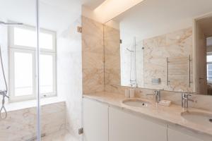a bathroom with a sink and a mirror at FLH Chiado Central Flat in Lisbon +6 photos