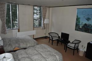 Postel nebo postele na pokoji v ubytování Petit Hotel Yukikkoso