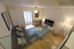 a living room with a couch and a glass table at FLH Porto Spacious Duplex in Porto