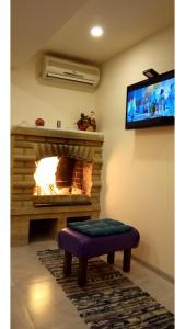 a living room with a fireplace and a tv at Lily`s Loft in Yerevan