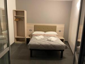 a small bedroom with a bed with two pillows at BICOCCA APPARTAMENTI in Milan