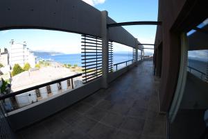 a balcony of a building with a view of the ocean at Ushuaia Flat I in Ushuaia