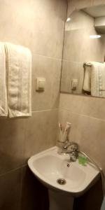 a bathroom with a sink and a mirror and towels at Lily`s Loft in Yerevan +21 photos