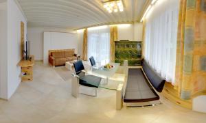 a living room with a table and a couch at Karglhof Bungalows in Faak am See
