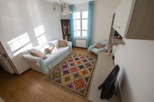 a living room with a couch and a rug at Perfect Wave a 10 m dal mare in Sanremo