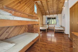 a bedroom with two bunk beds in a cabin at 112 Mooloomba Road in Point Lookout