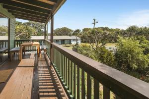 a balcony of a house with a view of the street at 112 Mooloomba Road in Point Lookout