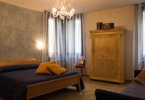a bedroom with a bed and a chandelier at Taverna San Lio in Venice