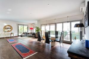 a living room with a couch and a table and chairs at Costa Maresme, Barcelona, Casa Burriac & Private Pool in Cabrils