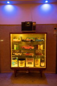 a display case in a store with a tv on top of it at Pao de Acucar Hotel in Porto