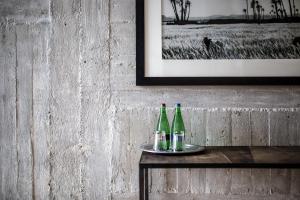 three bottles of wine on a table next to a picture at Speicher7 Hotel in Mannheim