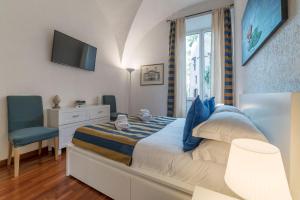 a bedroom with a bed and a desk and a television at CS Piazza Venezia Apartment in Rome