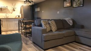 a living room with a couch and a kitchen at Four Cedars Accommodation in Jasper