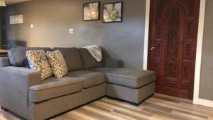 a living room with a couch and a brown door at Four Cedars Accommodation in Jasper