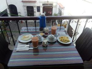 a table with food and drinks on a balcony at Misti Hostel B&B in Arequipa