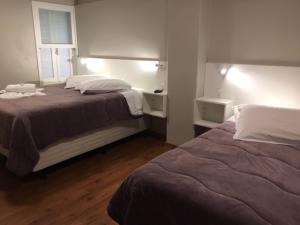 
A bed or beds in a room at Pousada dos Pinheirais
