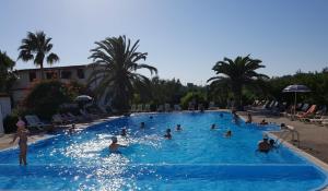 a group of people in a pool at a resort at Villaggio Alba Chiara in Vieste +31 photos