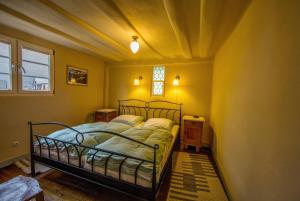 a bedroom with a bed in a yellow room at Fachwerk Anno 1628 in Ediger-Eller