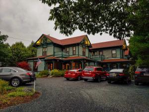 a large house with cars parked in a parking lot at The Primrose in Bar Harbor