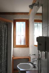 a bathroom with a sink and a window at Los Condores Bariloche in San Carlos de Bariloche