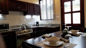 a kitchen with a table with dishes on it at Mirango Apartments in Boquete