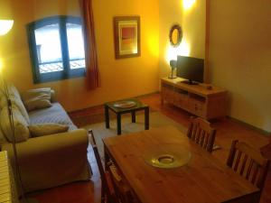 a living room with a couch and a table at Apartamentos Saltarel·lo in Besalú