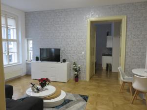 
a living room filled with furniture and a tv at Aapartamentoos in Bratislava
