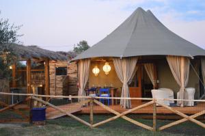 a large tent in front of a cabin at E-glamping/Blue Saphir Tent in Arezzo
