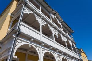 a facade of a building with white trim at Haus Sonne in Ostseebad Sellin