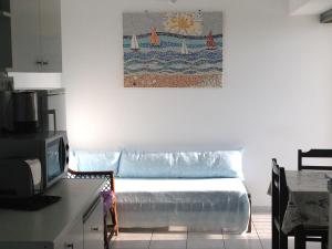 a couch in a room with a painting on the wall at Stunning Seaview Town Apartment in Agios Nikolaos +36 photos