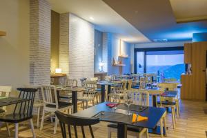 a restaurant with tables and chairs with a view at O balcón da ribeira in Parada del Sil