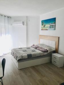 a bedroom with a bed in a white room at Estudio Habaneras,38 p 103 in Torrevieja