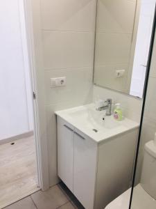 a white bathroom with a sink and a mirror at Estudio Habaneras,38 p 103 in Torrevieja +3 photos