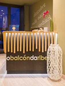 a store with a wooden fence and a vase at O balcón da ribeira in Parada del Sil